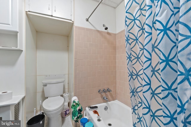 bathroom with toilet and shower / bath combo with shower curtain