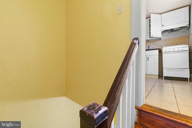 stairs with tile patterned floors