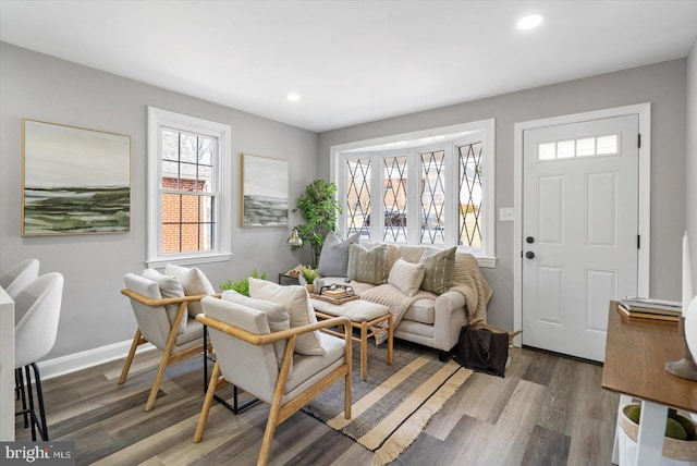 living room with recessed lighting, baseboards, and wood finished floors