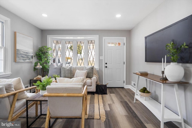 living area with visible vents, recessed lighting, baseboards, and wood finished floors