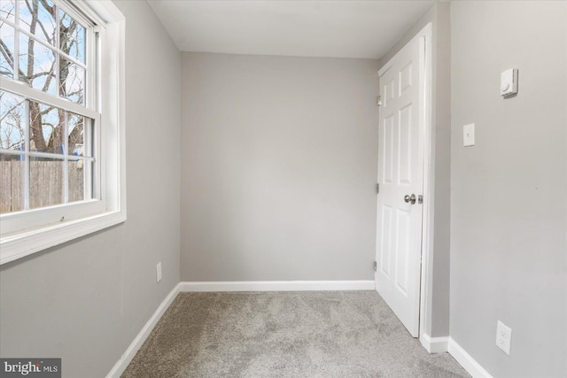 unfurnished room featuring baseboards and carpet flooring