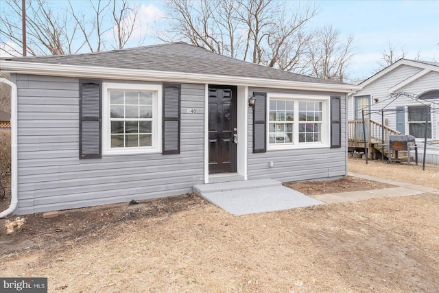 view of front of home featuring a shingled roof