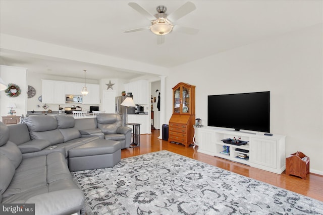 living area featuring ceiling fan and wood finished floors