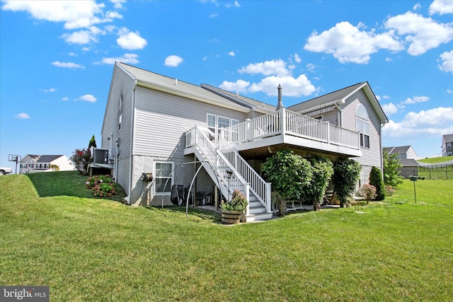 back of property with a deck, stairway, and a yard