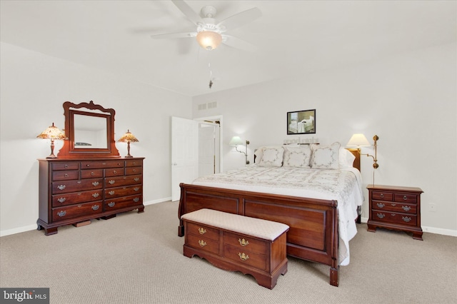 carpeted bedroom with visible vents, a ceiling fan, and baseboards