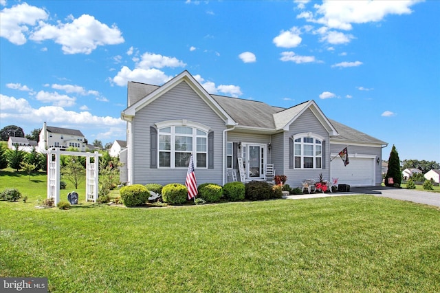 ranch-style home featuring a garage, a front lawn, and driveway