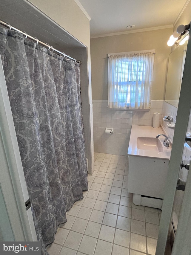 full bathroom with vanity, ornamental molding, wainscoting, tile patterned floors, and tile walls