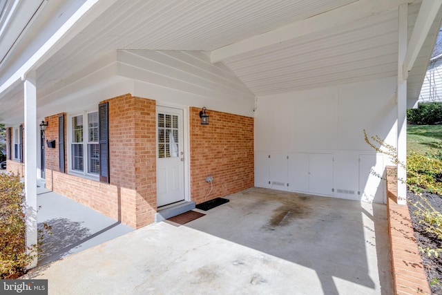 exterior space with visible vents, a carport, covered porch, and concrete driveway