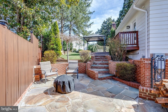 view of patio / terrace featuring a gazebo and fence