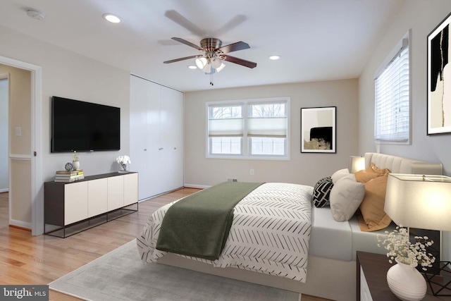 bedroom with recessed lighting, multiple windows, and wood finished floors