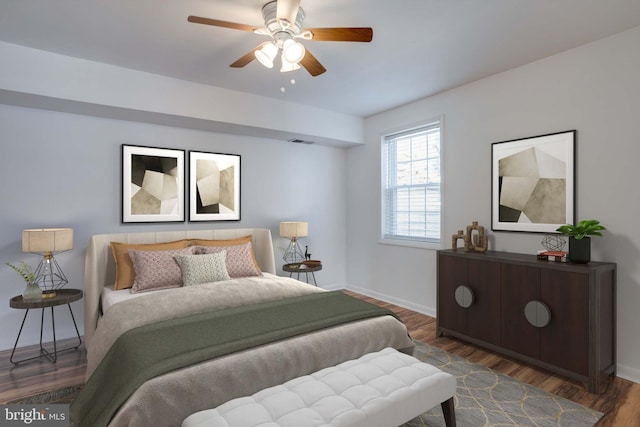 bedroom featuring visible vents, a ceiling fan, baseboards, and wood finished floors