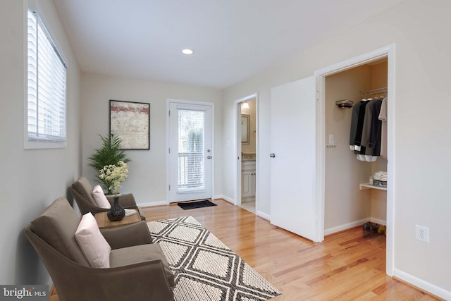 foyer featuring recessed lighting, light wood-style floors, and baseboards