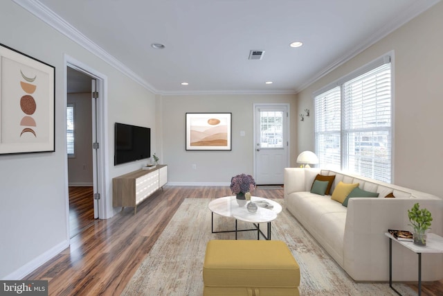 living room featuring recessed lighting, wood finished floors, baseboards, and ornamental molding