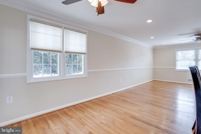 unfurnished room featuring wood finished floors, a ceiling fan, baseboards, and ornamental molding