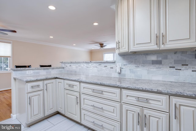 kitchen with a wealth of natural light, ceiling fan, and crown molding