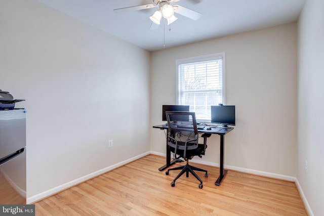 home office with ceiling fan, baseboards, and wood finished floors