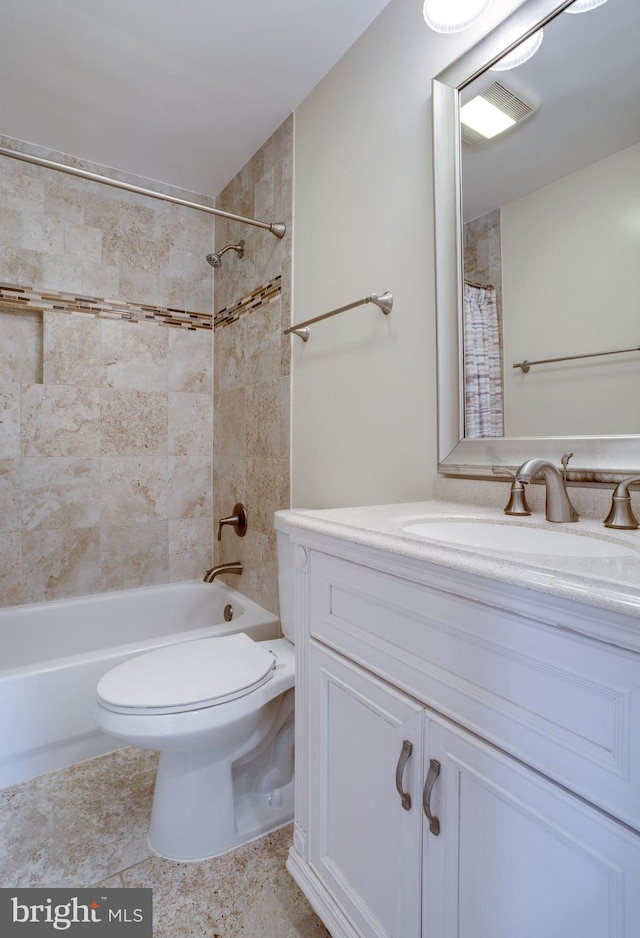 bathroom with vanity, toilet, and shower / bath combo