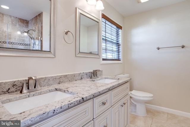 full bathroom with tile patterned flooring, toilet, a tile shower, and a sink