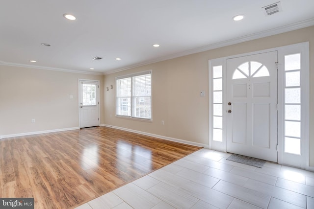 entrance foyer with light wood finished floors, visible vents, recessed lighting, and ornamental molding