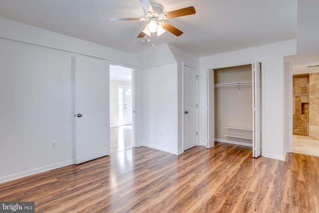 unfurnished bedroom with baseboards, wood finished floors, and a ceiling fan