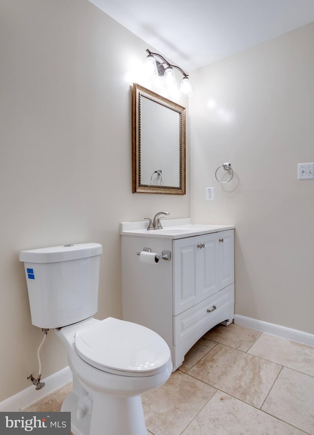 bathroom featuring tile patterned floors, toilet, vanity, and baseboards