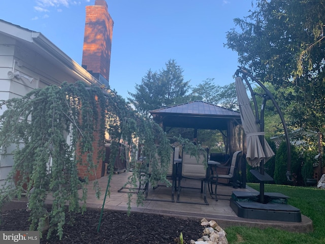 view of yard featuring a gazebo and a patio area