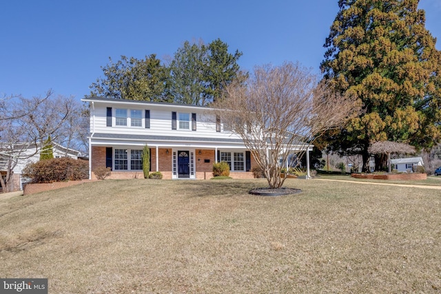 view of front of home featuring brick siding and a front yard