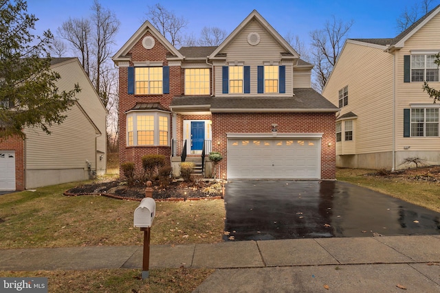 traditional-style home with brick siding, a shingled roof, aphalt driveway, and a garage