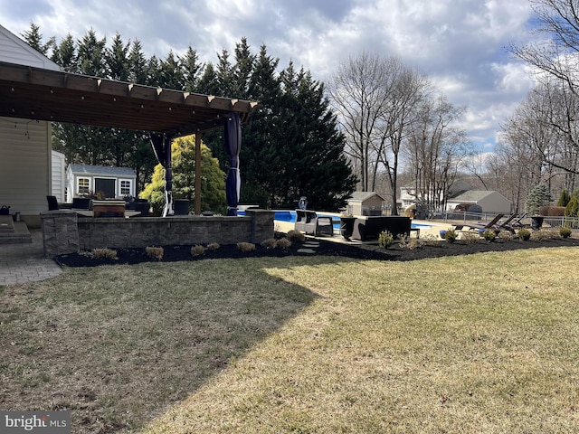 view of yard featuring a pergola, an outbuilding, an outdoor pool, and a patio area