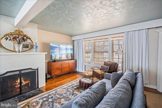 living area with a fireplace and wood finished floors