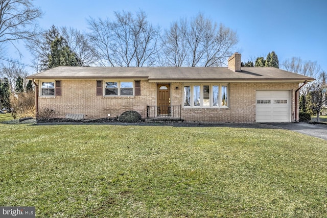 ranch-style house featuring an attached garage, a chimney, a front lawn, aphalt driveway, and brick siding