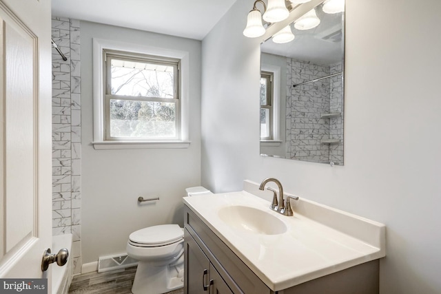 full bath with visible vents, baseboards, toilet, wood finished floors, and vanity