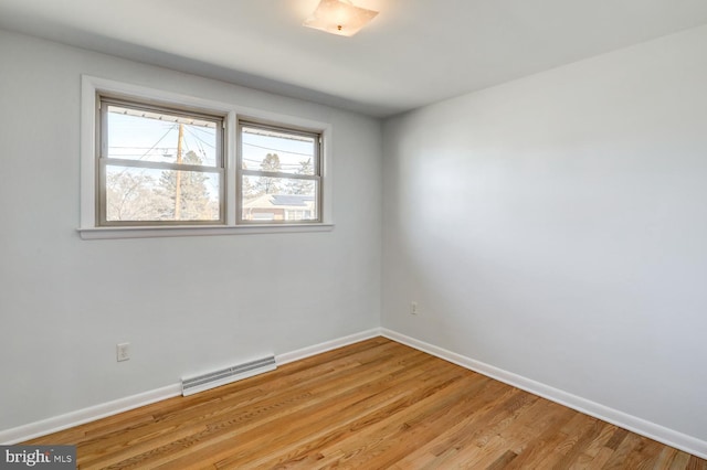 spare room with visible vents, baseboards, and light wood finished floors