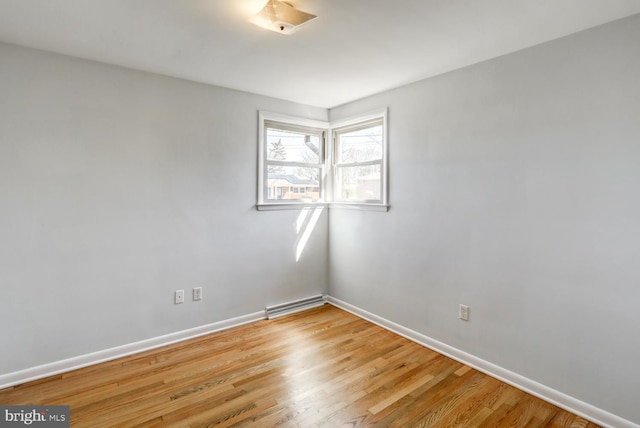 spare room featuring baseboards, visible vents, and light wood-type flooring