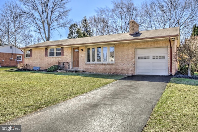 ranch-style house with an attached garage, a chimney, a front lawn, aphalt driveway, and brick siding