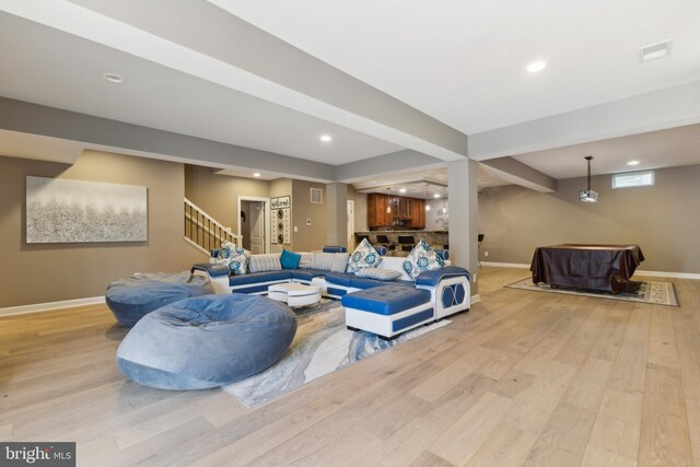 living room featuring visible vents, baseboards, stairs, recessed lighting, and light wood-style flooring