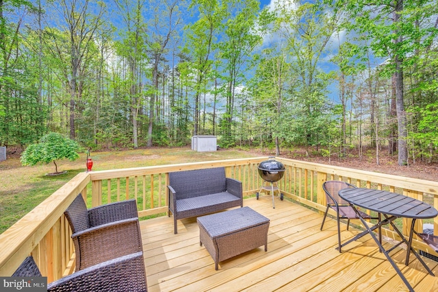 wooden deck with a storage shed and an outbuilding