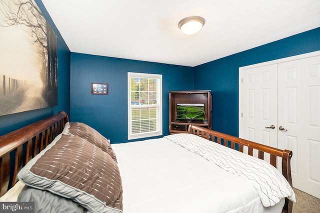 carpeted bedroom featuring a closet