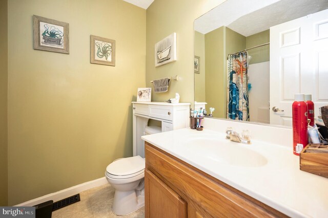 bathroom featuring toilet, visible vents, tile patterned flooring, a shower with shower curtain, and vanity