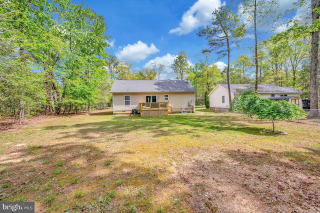 back of house with a lawn, crawl space, and a deck