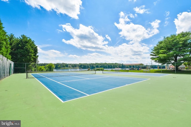 view of tennis court featuring fence