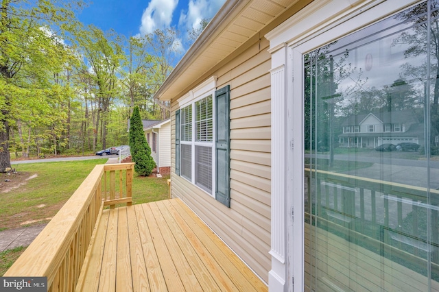 wooden terrace with a lawn