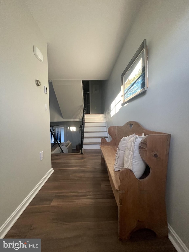 living area featuring stairs, baseboards, and wood finished floors