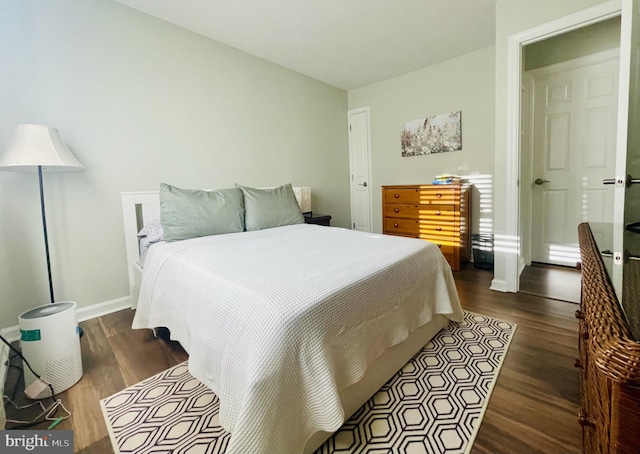 bedroom featuring wood finished floors and baseboards