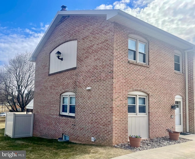 view of home's exterior with brick siding