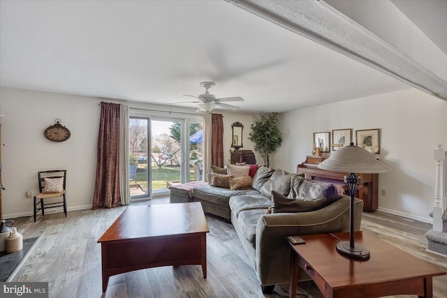 living area with ceiling fan, baseboards, and wood finished floors