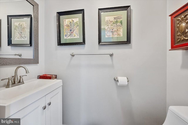 half bath featuring toilet and vanity