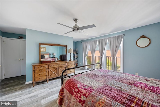 bedroom featuring access to exterior and wood finished floors