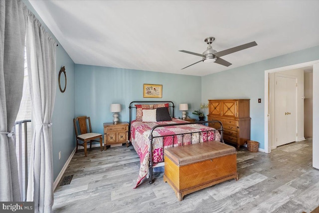 bedroom with visible vents, light wood-type flooring, and baseboards