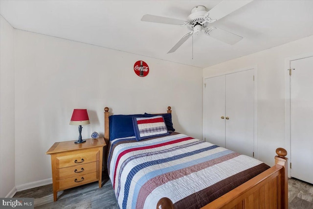 bedroom with a closet, wood finished floors, and ceiling fan